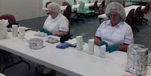 Handwrapping the blue cheese wedges